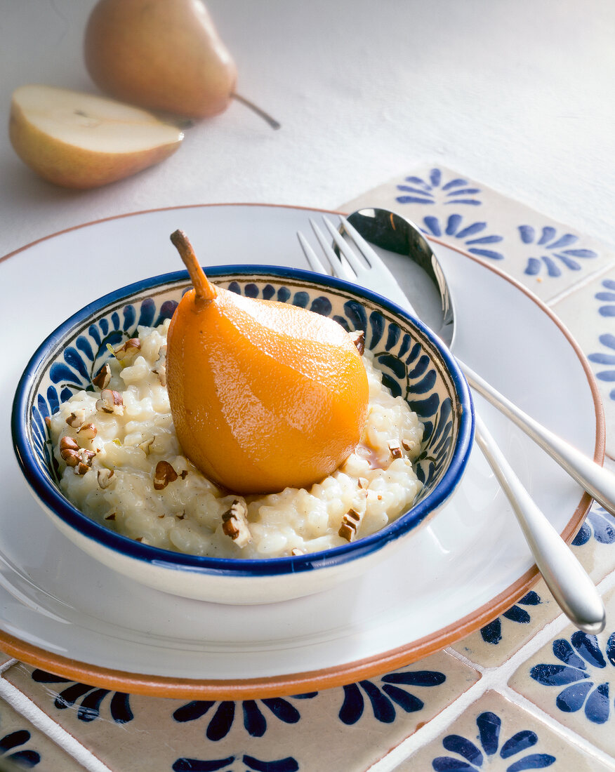 Bowl of tequila poached pear on rice pudding