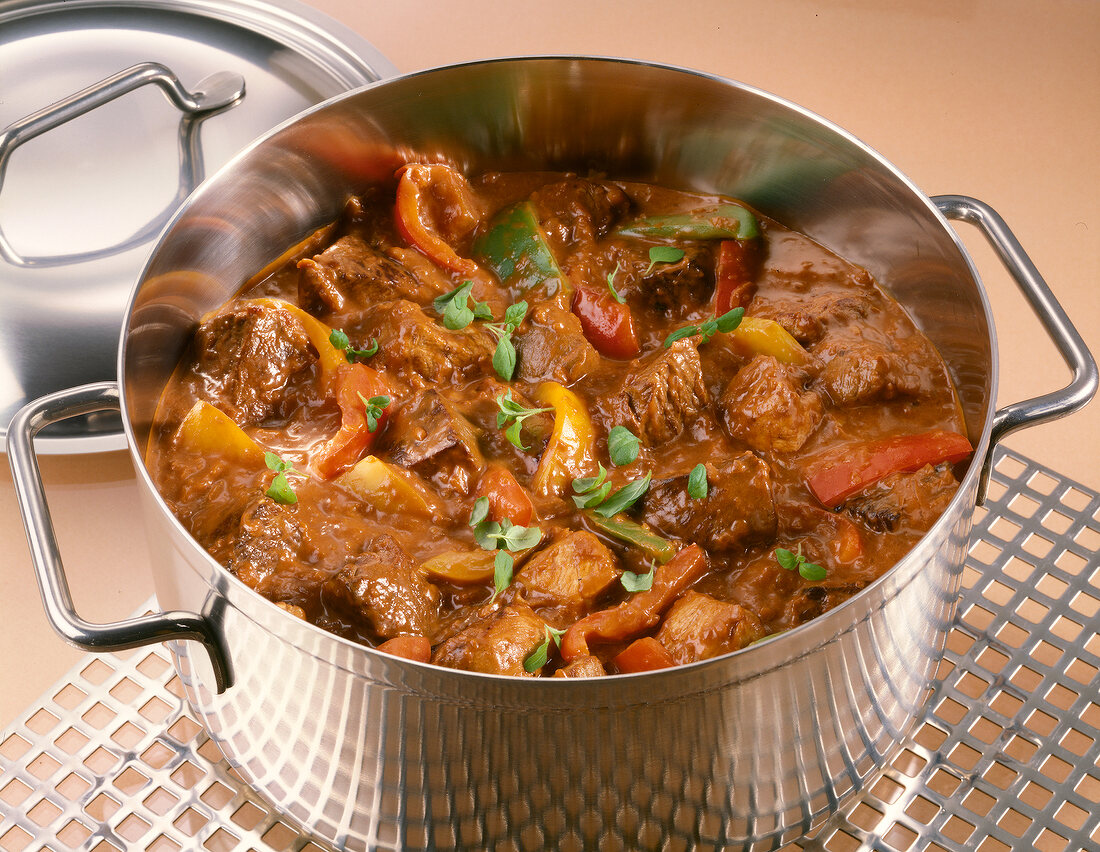 Hungarian national dish with goulash and paprika in steel casserole
