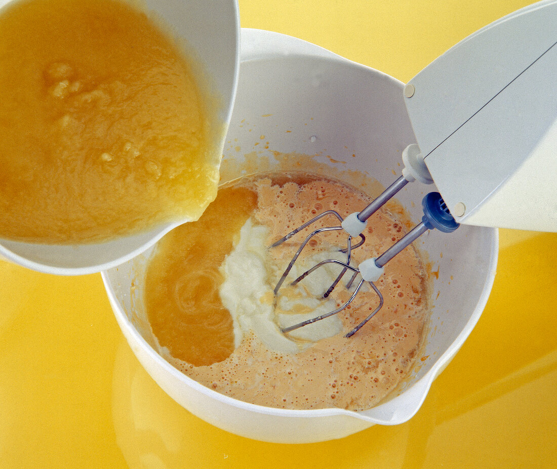 Pineapple with almond paste, egg yolks, powdered sugar and yogurt blended in bowl