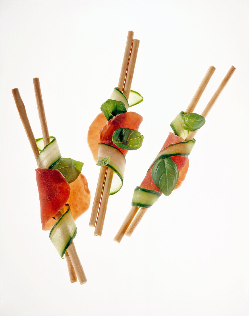 Close-up of breadsticks with ham and cucumber, appetizers