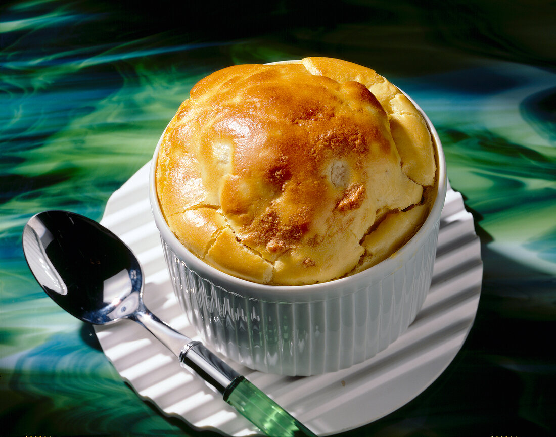 Close-up of cheese and walnut souffle in a souffle dish