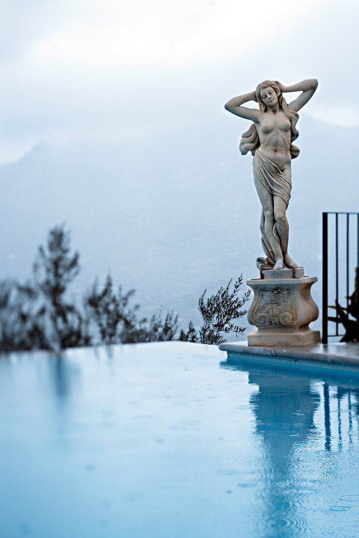 Statue of woman at swimming pool