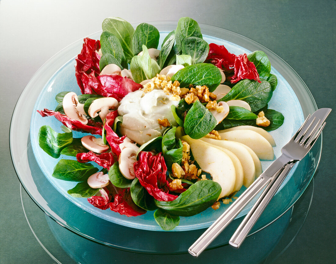 Close-up of radicchio lettuce with pears, mushrooms and walnuts in bowl