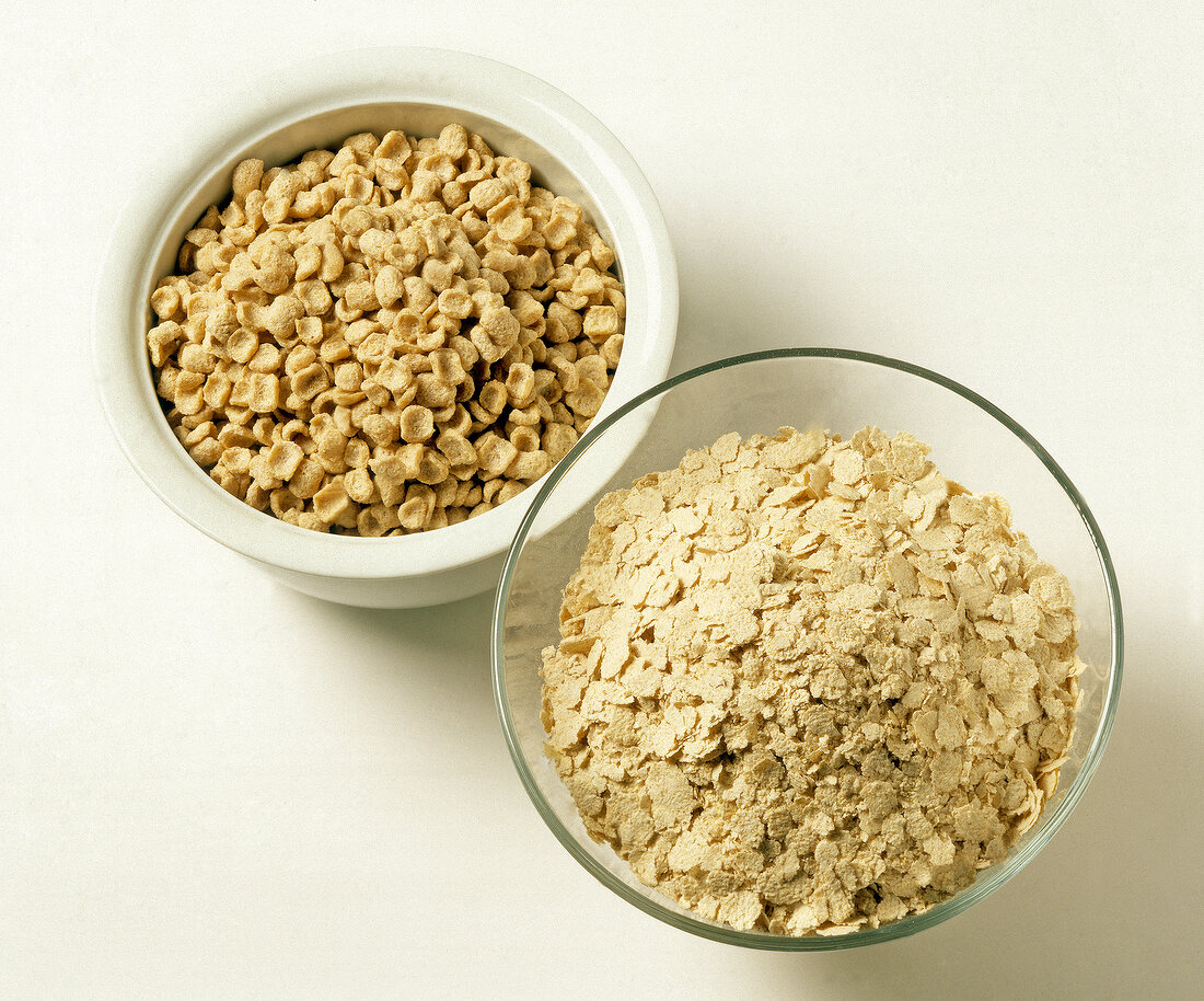 Close-up of two bowls with oat bran and oat bran flakes