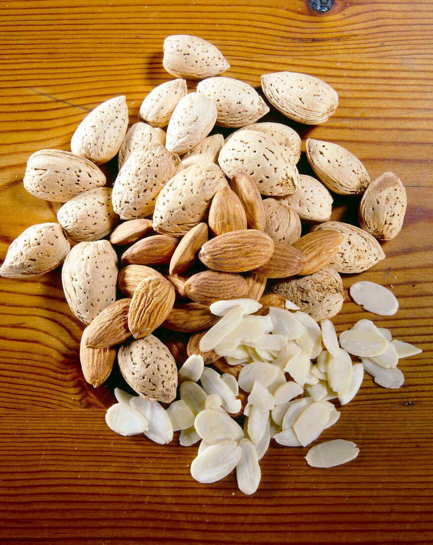 Close-up of almonds with shell and without shell, finely chopped almonds