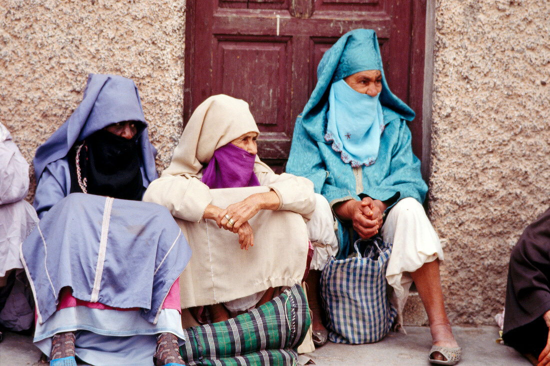 Women wearing Islamic veil waiting for customers in old town