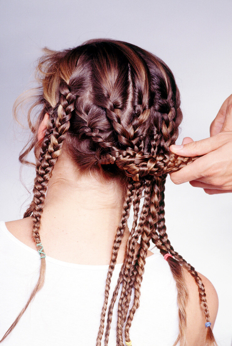 Close-up of woman's braided hair being joined together
