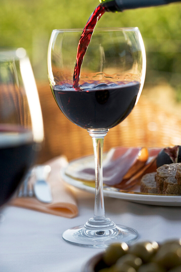 Close-up of glass being filled with red wine in Mallorca, Spain