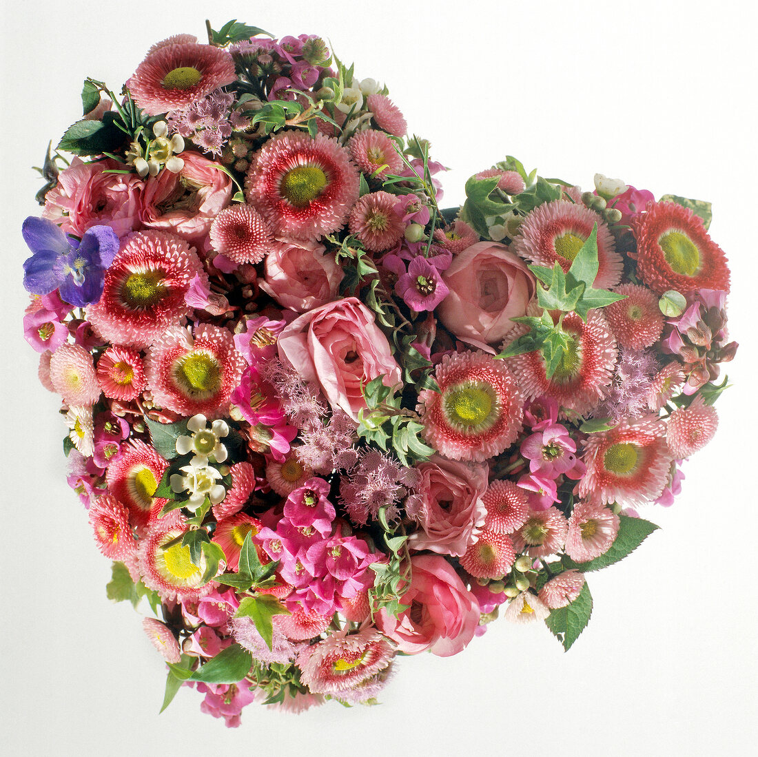 Close-up of heart shaped flower arrangements with pink roses and daisies