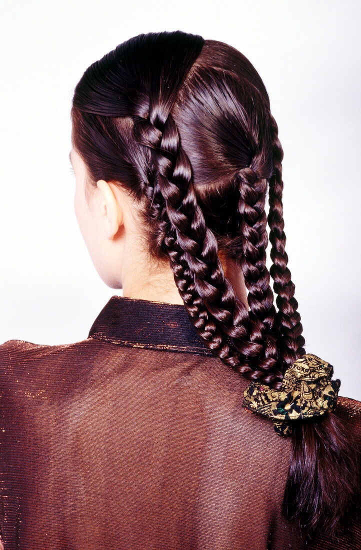 Rear view of woman with four braids tied with rubber band