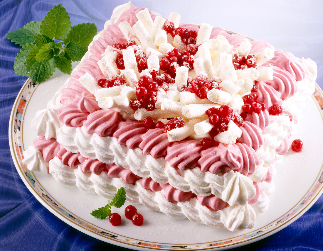 Meringue cake with red currant cream on plate