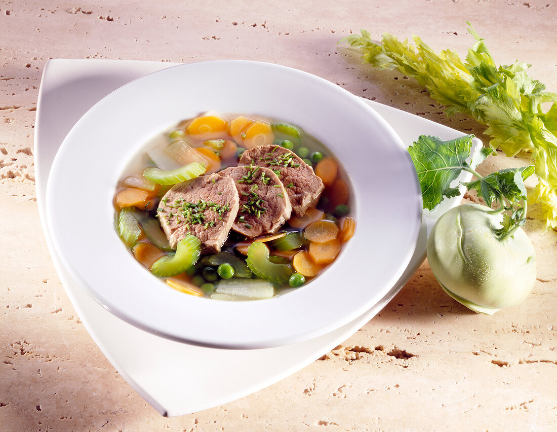 Bowl of vegetable stew with fillet of veal, carrots, kohlrabi, peas and celery
