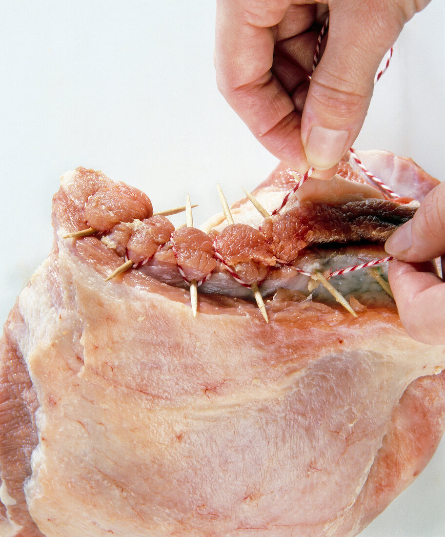 Stuffed veal breast pined up with toothpick