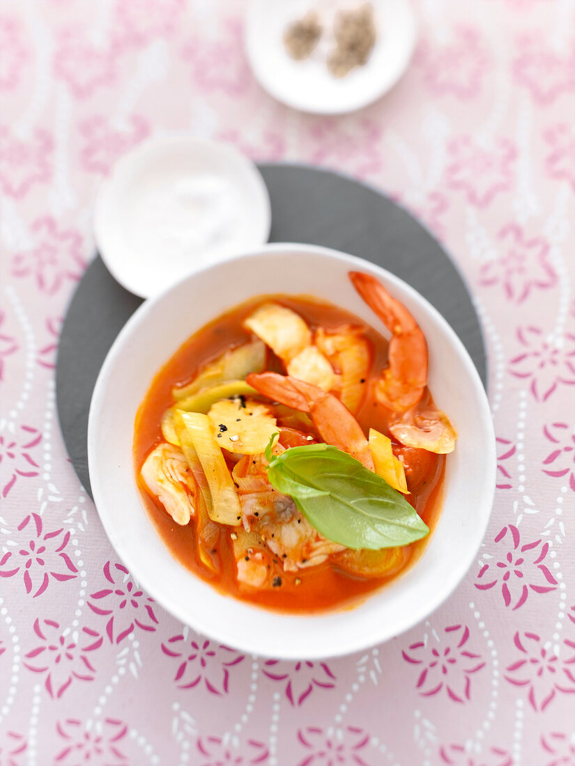 Bowl of fish soup with tomatoes