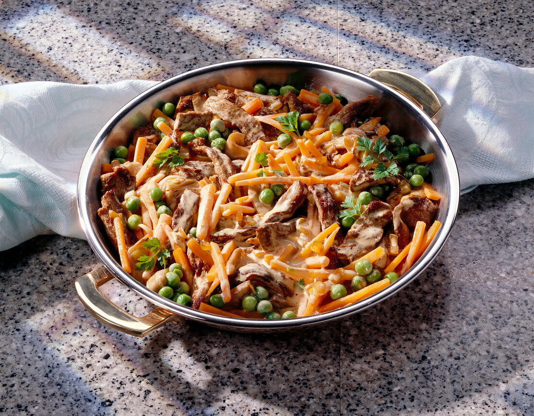 Beef with peas, carrots and oyster mushrooms in casserole
