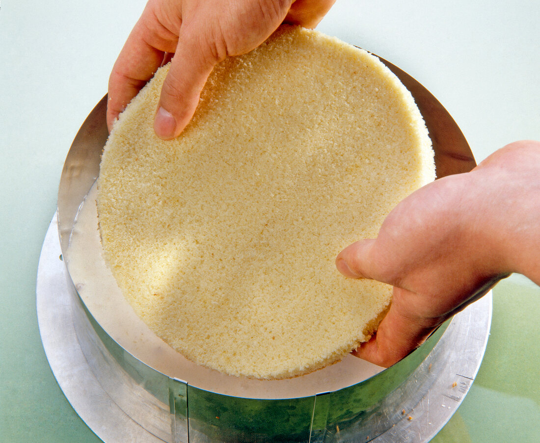 Placing biscuit base in cake mould