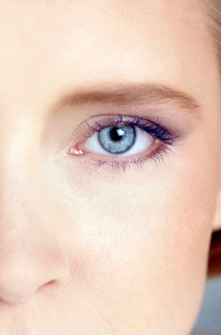 Extreme close-up of gray eyed woman wearing subtle eye make-up