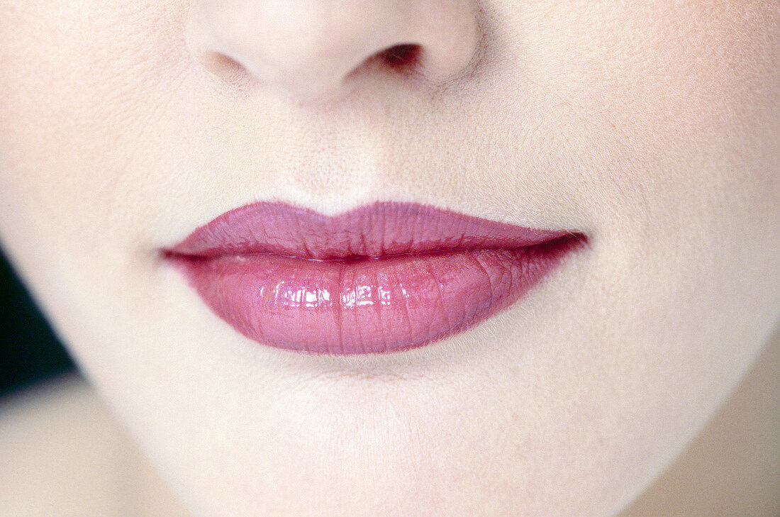 Extreme close-up of woman wearing pink lipstick