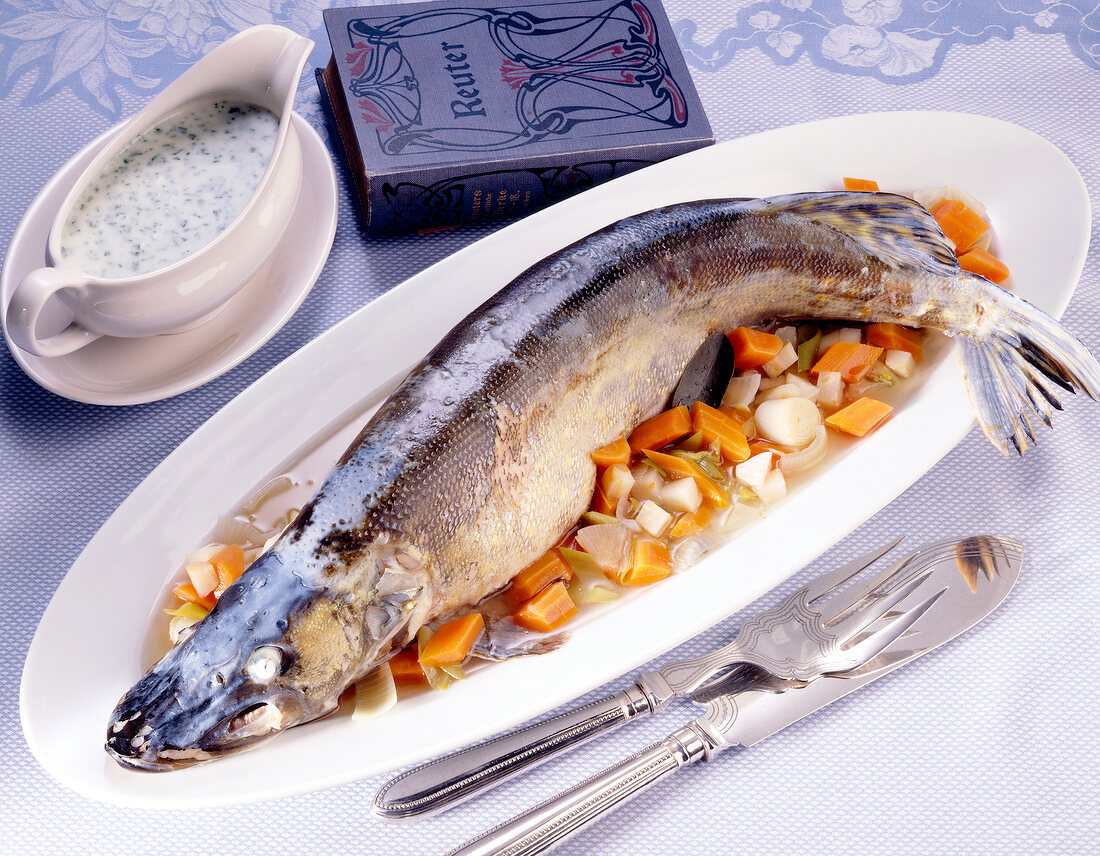 Pike fish broth with vegetables in bowl and parsley sauce in cup