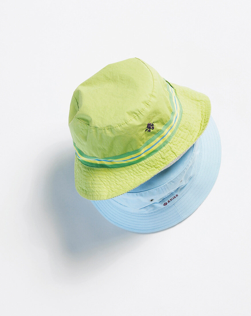 Close-up of green and blue hat on white background