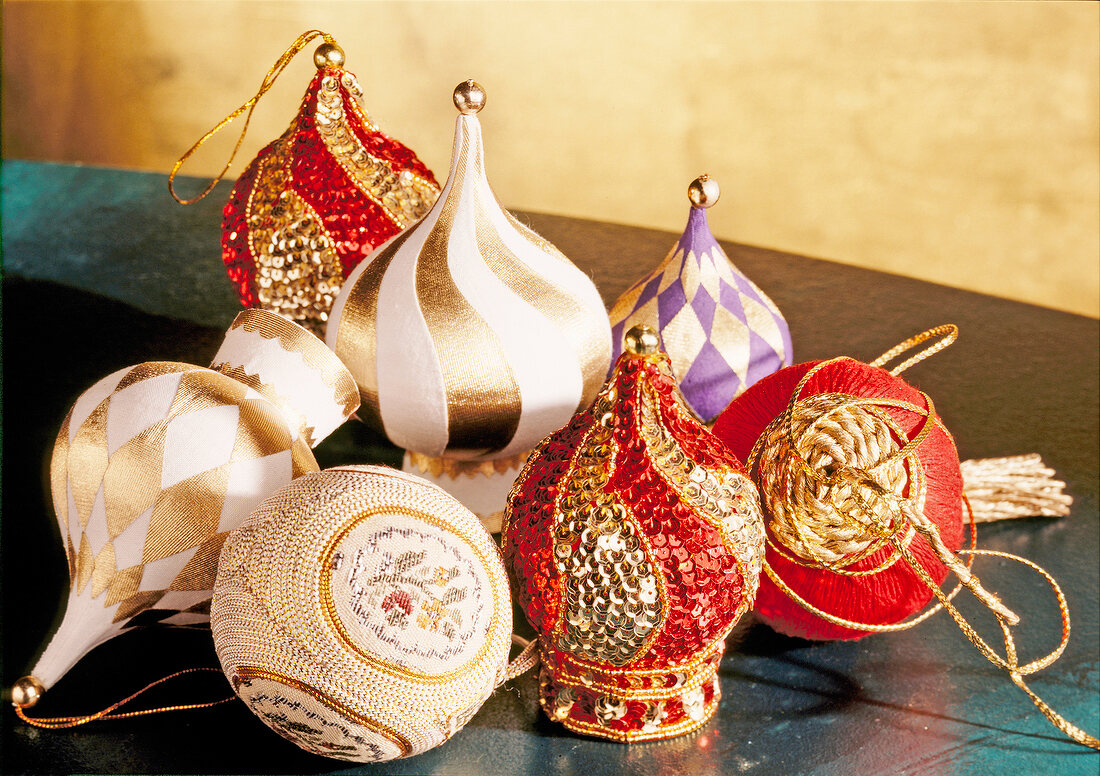 Close-up of decorated Christmas tree baubles with gold and red sequins