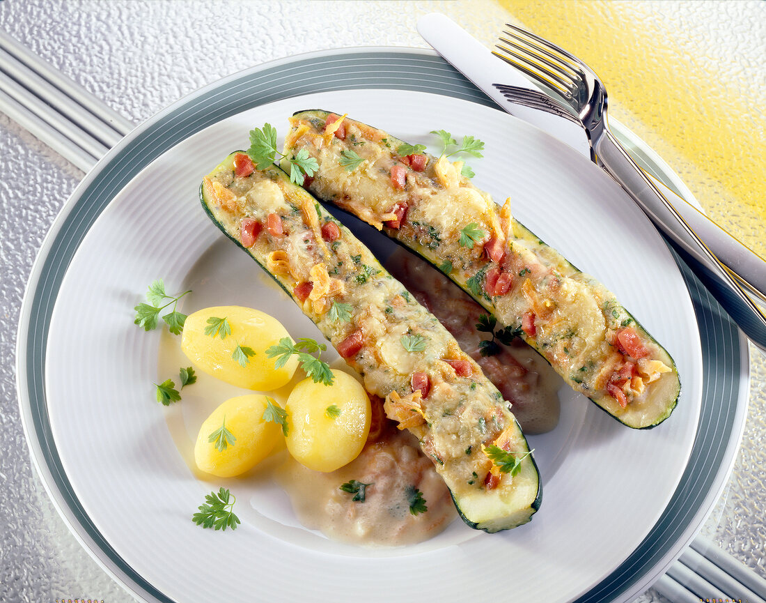 Zucchini with carrots-cheese stuffing and potatoes on plate