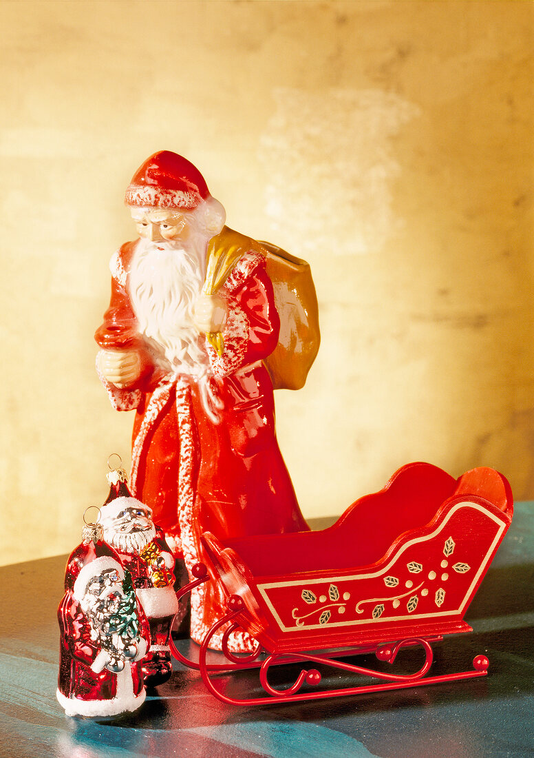 Red ceramic Santa Claus and sledge for Christmas decoration
