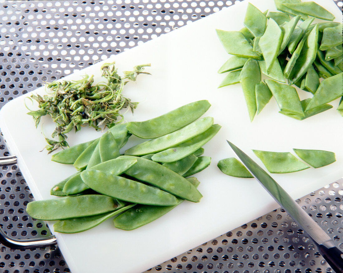 Chopped pieces of seabrass for preparation of fish on chopping board