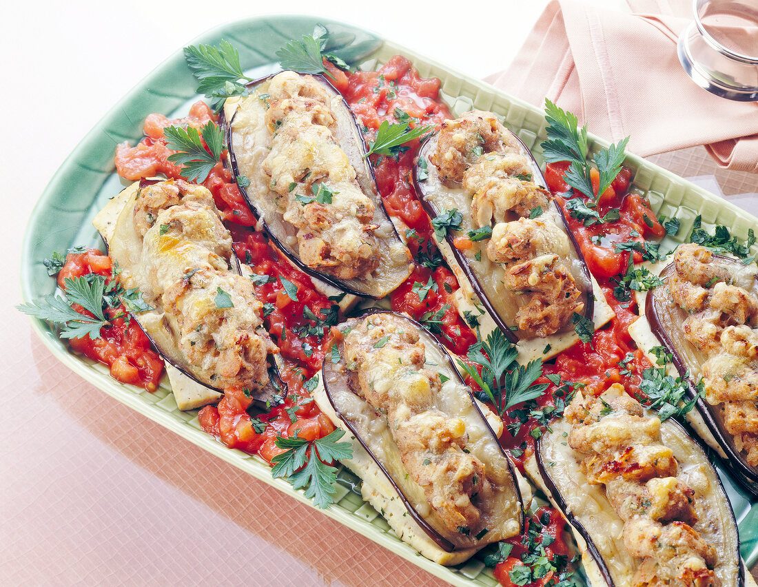 Tofu eggplant cutlet with tomato sauce and herbs on plate