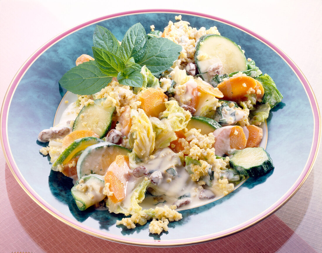 Millet vegetable with stir-fry ginger, raisins and mint leaves on plate