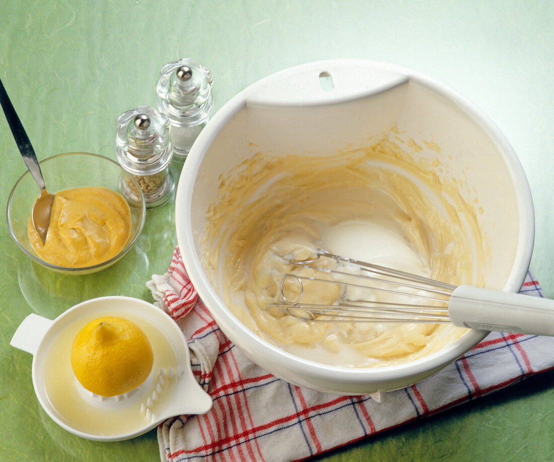 Whisk beat with other ingredients on table for making mayonnaise