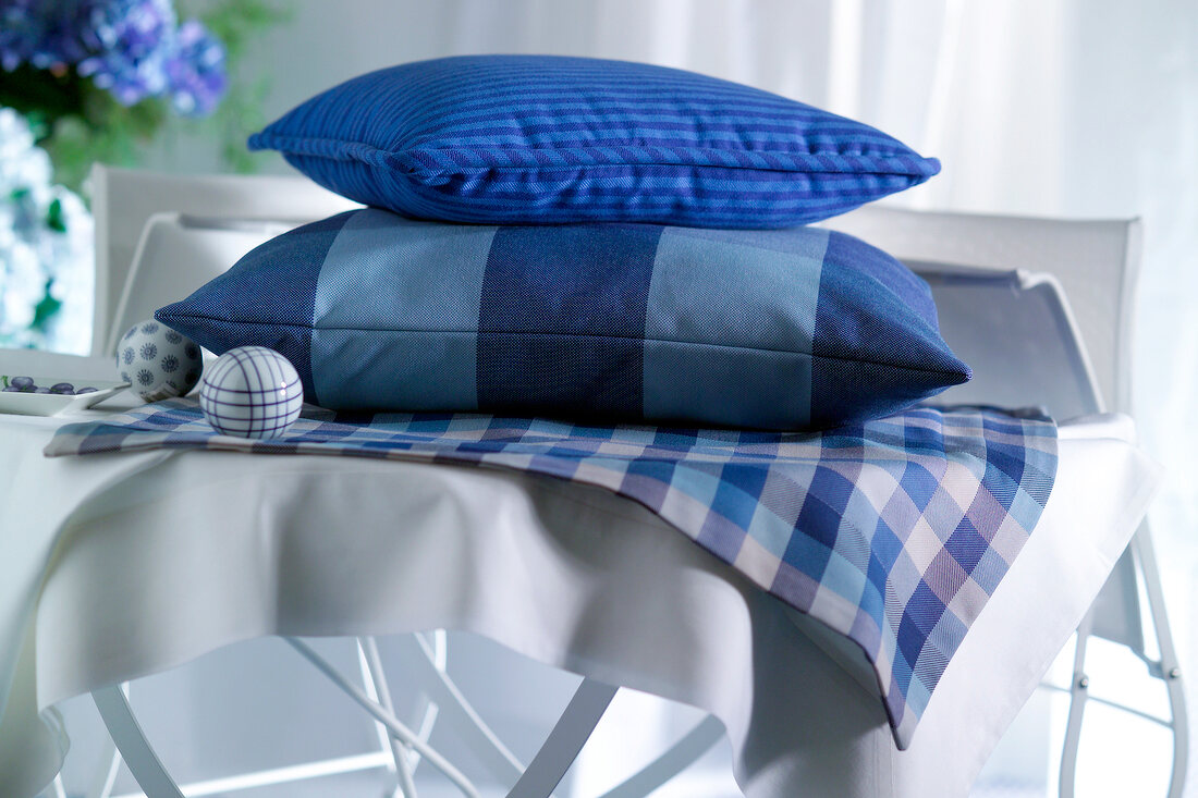 Blue cushions on plaid tablecloth