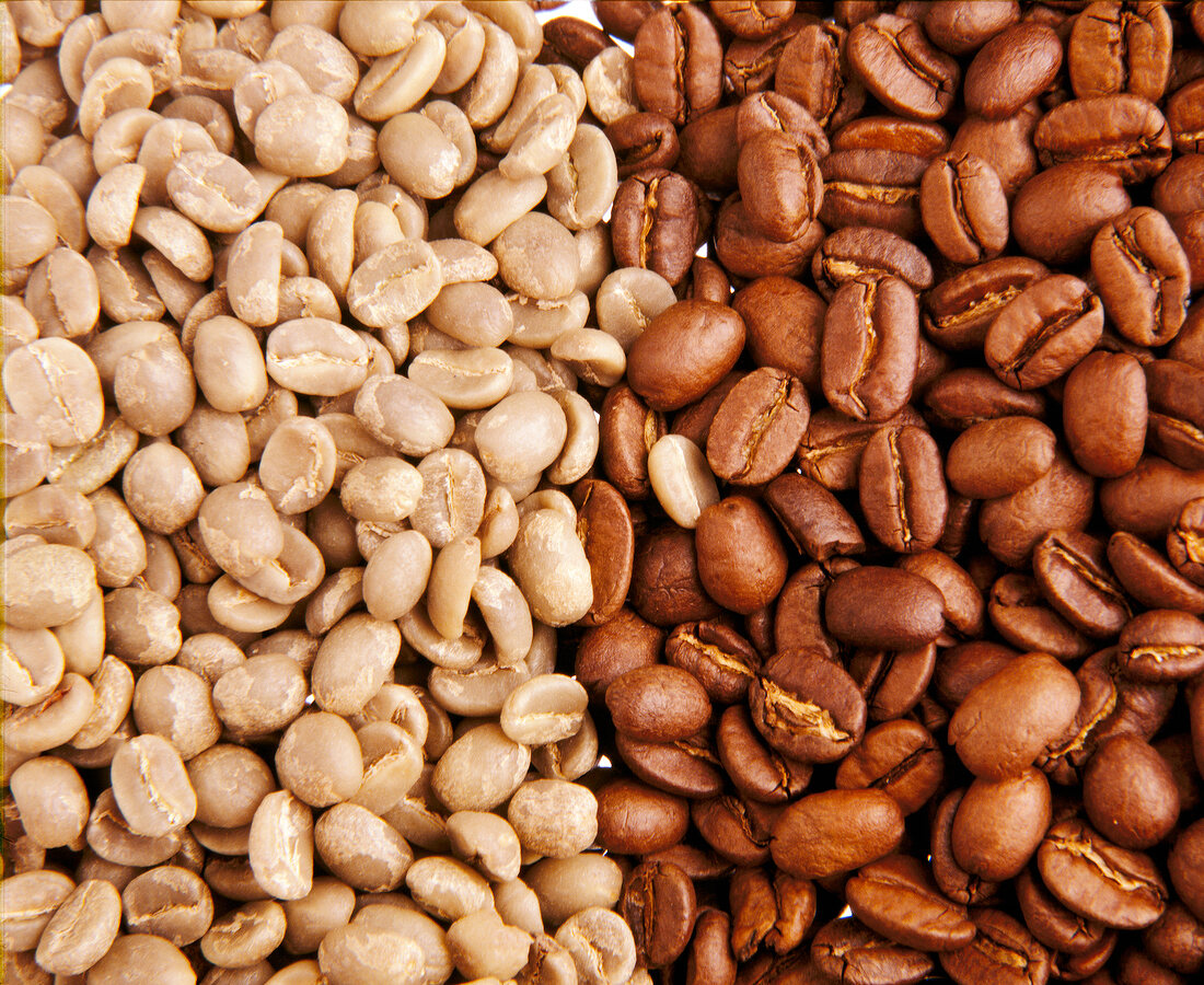Close-up of unroasted and roasted Arabica coffee beans, full frame