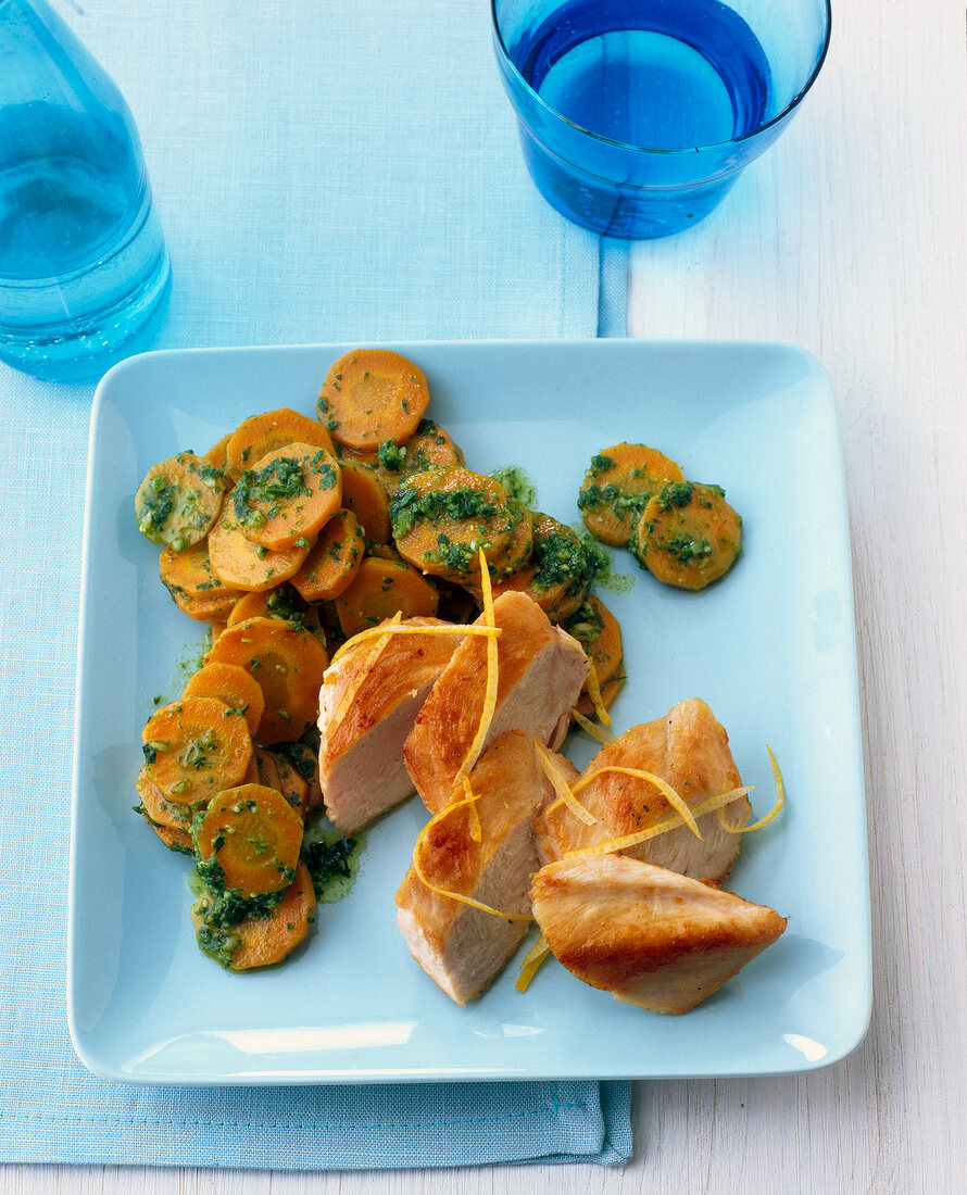 Chicken breast with pesto carrots on plate