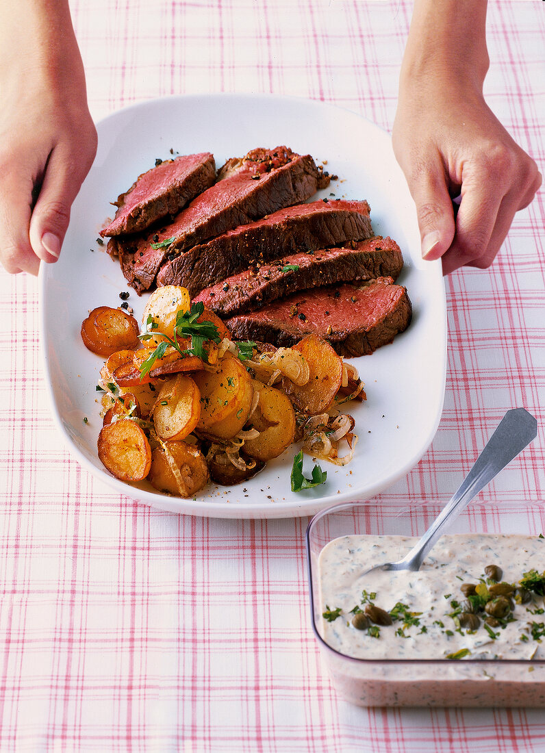 Tender beef roasted with remoulade on white plate