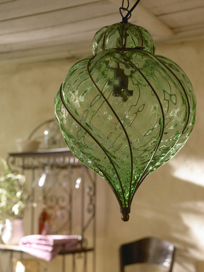 Close-up of green glass lamp