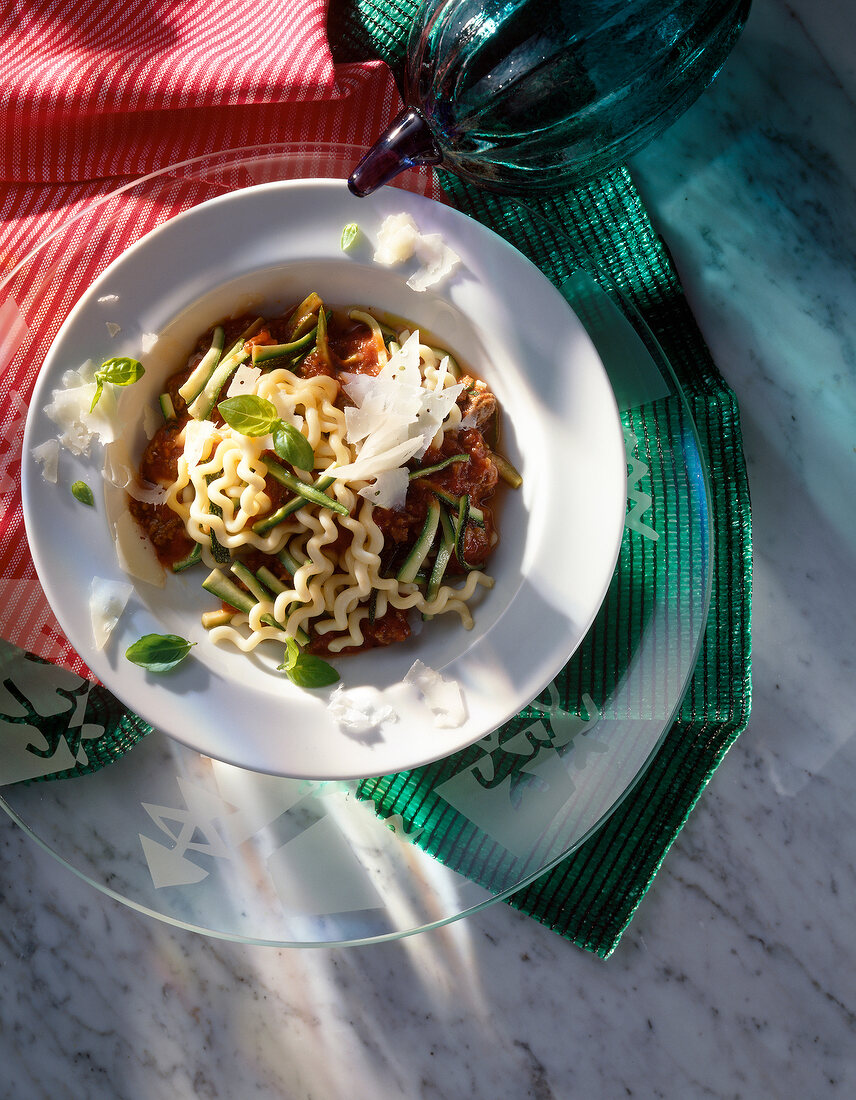 Pasta with meat sauce and zucchini on plate