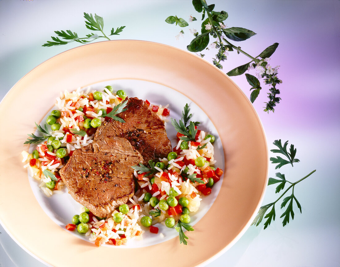 Beef fillets with vegetable and rice on plate