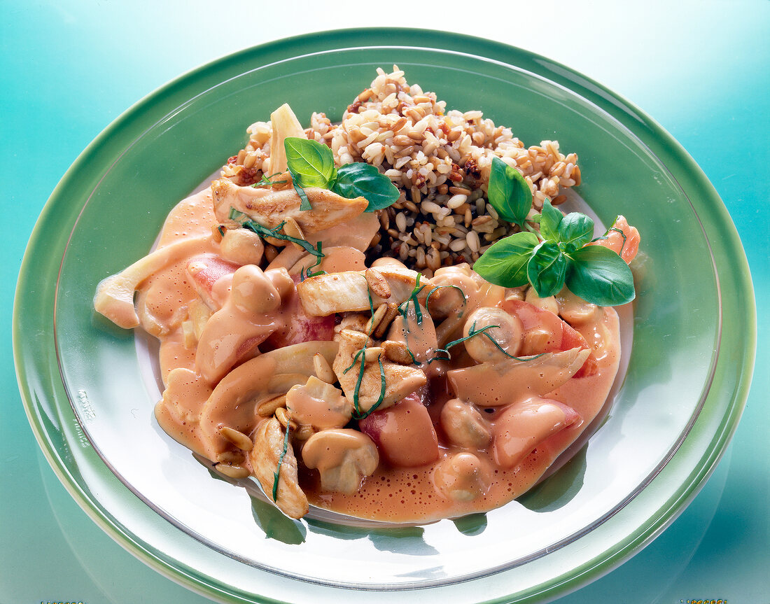 Mushroom and fennel ragout with brown rice and basil on glass plate