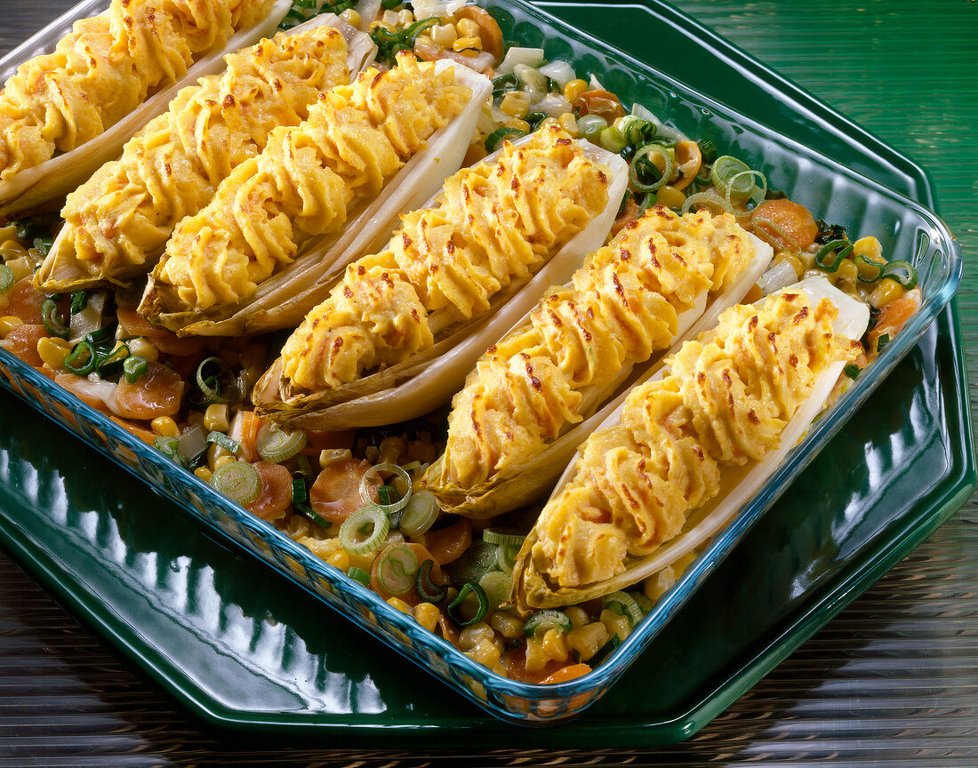 Chicory with carrots and almond stuffing in tray