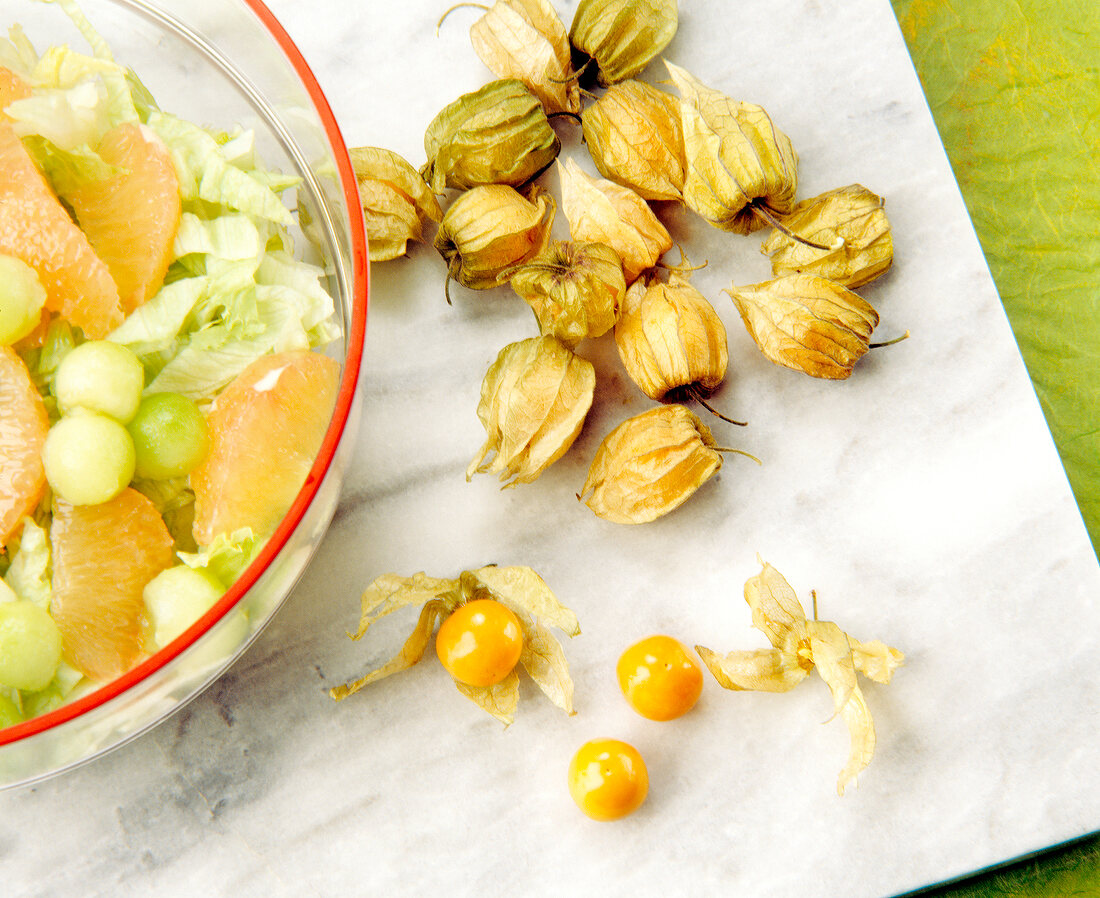 Close-up of cape gooseberries on chopping board
