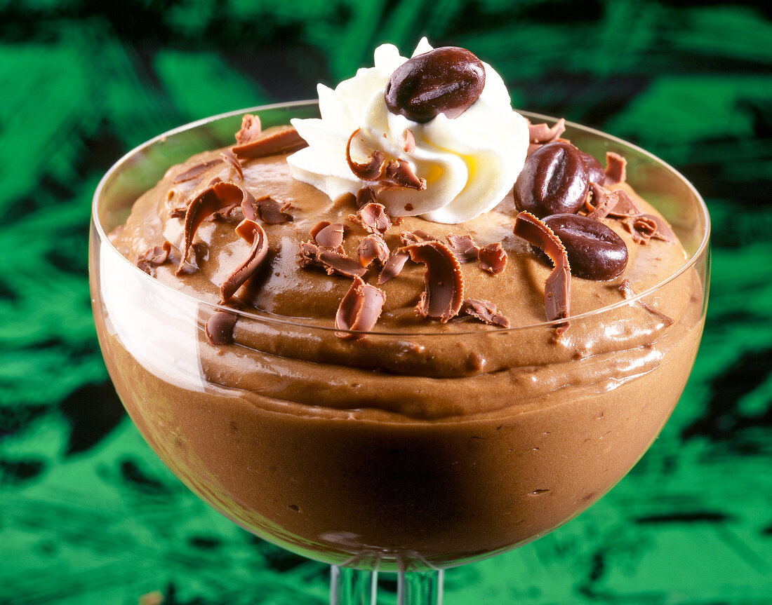 Close-up of chocolate mocha cream with coffee beans in bowl