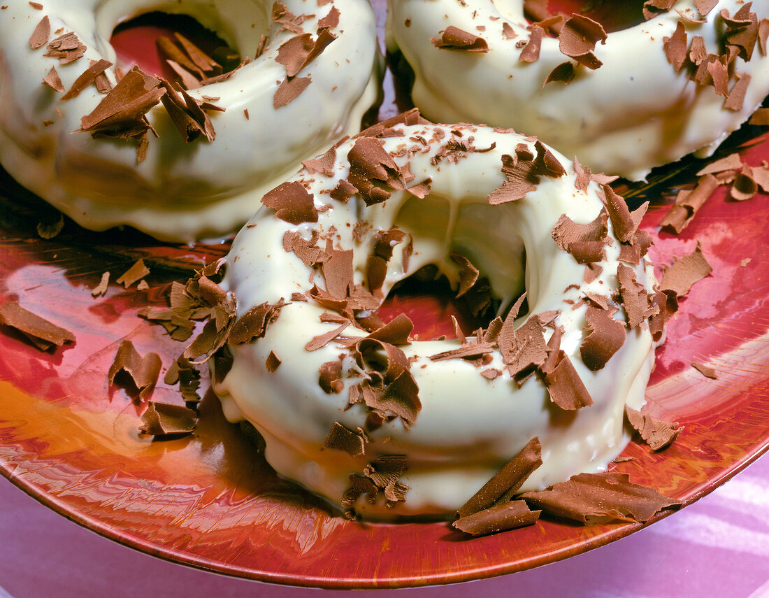 Close-up of nougat rings with marzipan icing in white chocolate