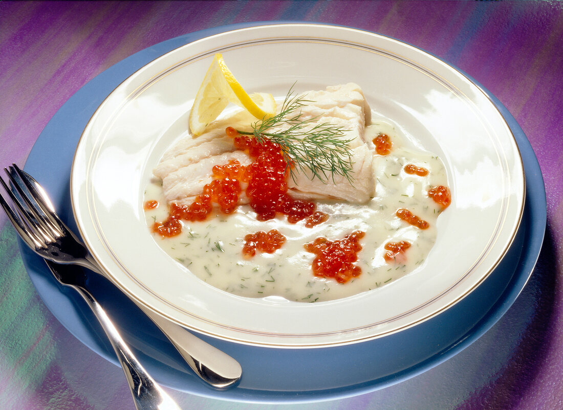 Cod fillet with dill sauce on plate