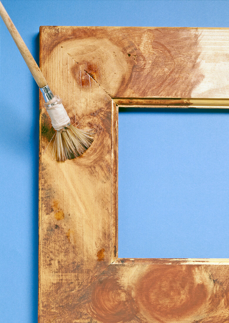 Close-up of photo frame with brush on blue background