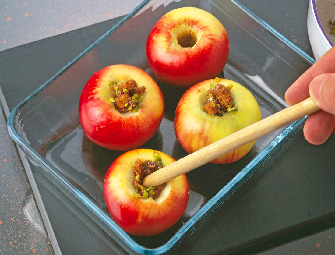 Stuffing the apples with filling in baking dish
