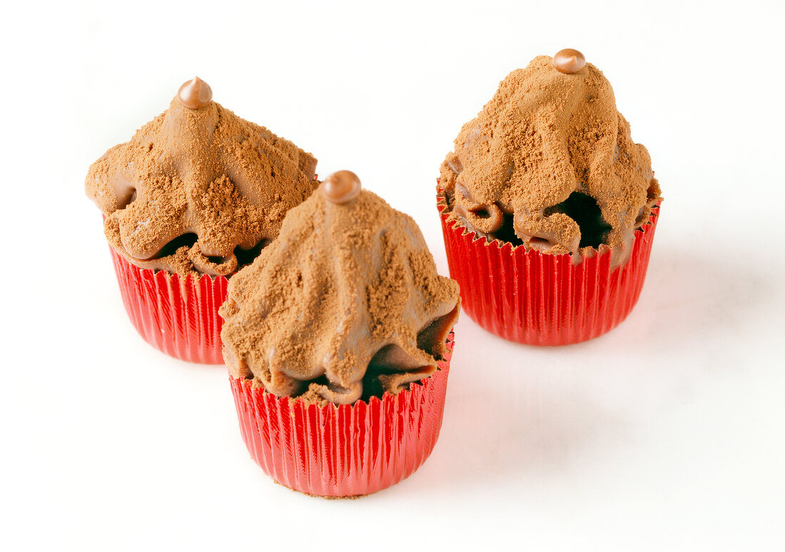 Chocolate cream truffles on white background