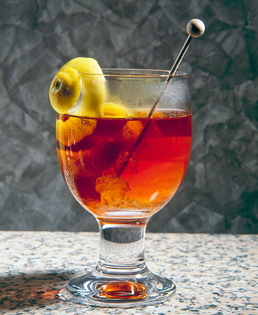 Close-up of sherry punch with lemon spiral in glass