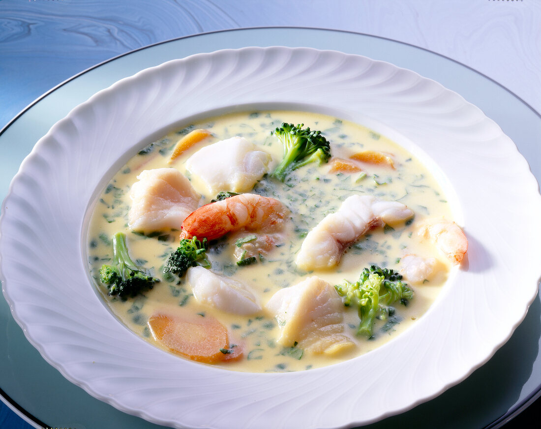 Bowl of fish soup with king prawns and saffron
