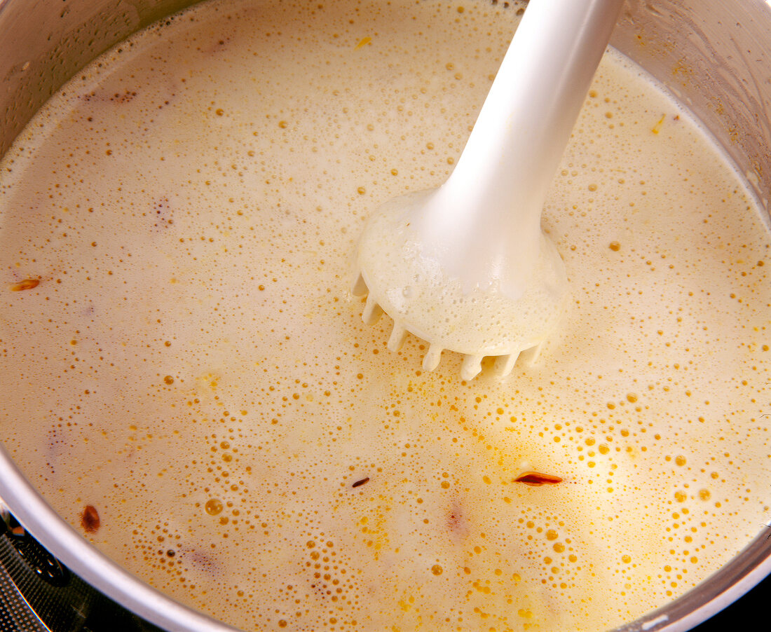 Close-up of cream cheese mixed with hand mixer